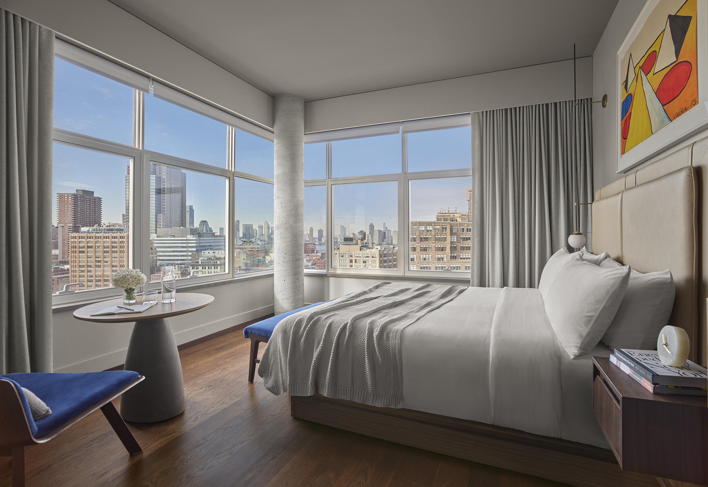 A Skyline King studio at the ModernHaus hotel in Soho, Manhatatn with king size bed, breakfast table and views of lower manhattan